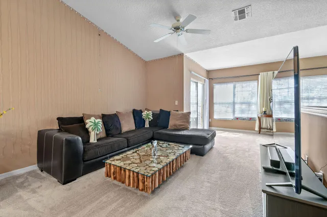 a living room with furniture and large windows