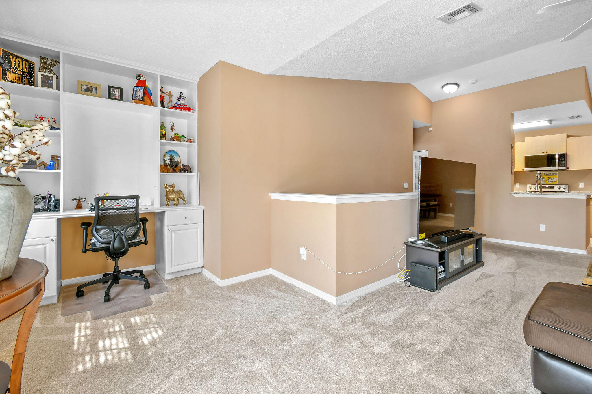 10354 Fox Trail Road South, Unit 1505 West Palm Beach, FL 33411 - Photo 50 of 76 a living room with furniture and a flat screen tv
