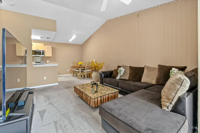 a kitchen with stainless steel appliances kitchen island granite countertop a refrigerator and a stove top oven