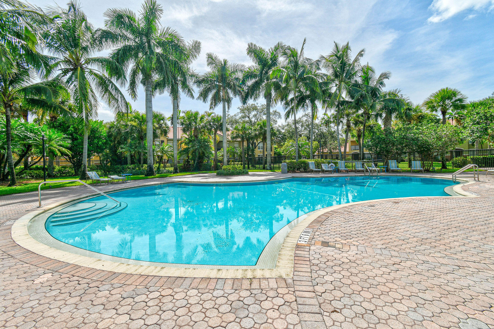 10354 Fox Trail Road South, Unit 1505 West Palm Beach, FL 33411 - Photo 71 of 76 a view of a swimming pool with a yard