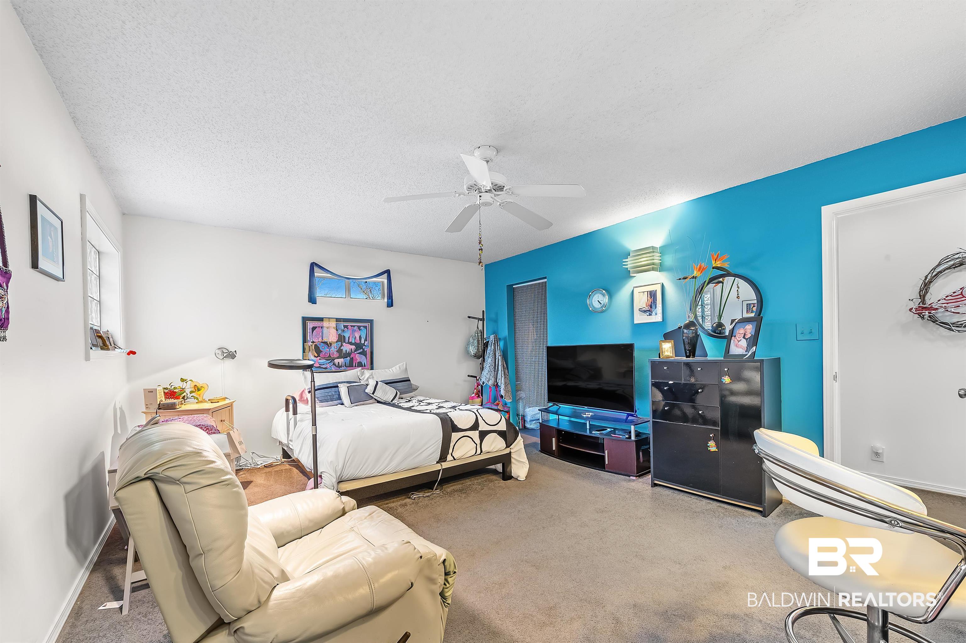 526 Ariel Avenue Foley, AL 36535 - Photo 25 of 33 Carpeted bedroom featuring ceiling fan and a textured ceiling
