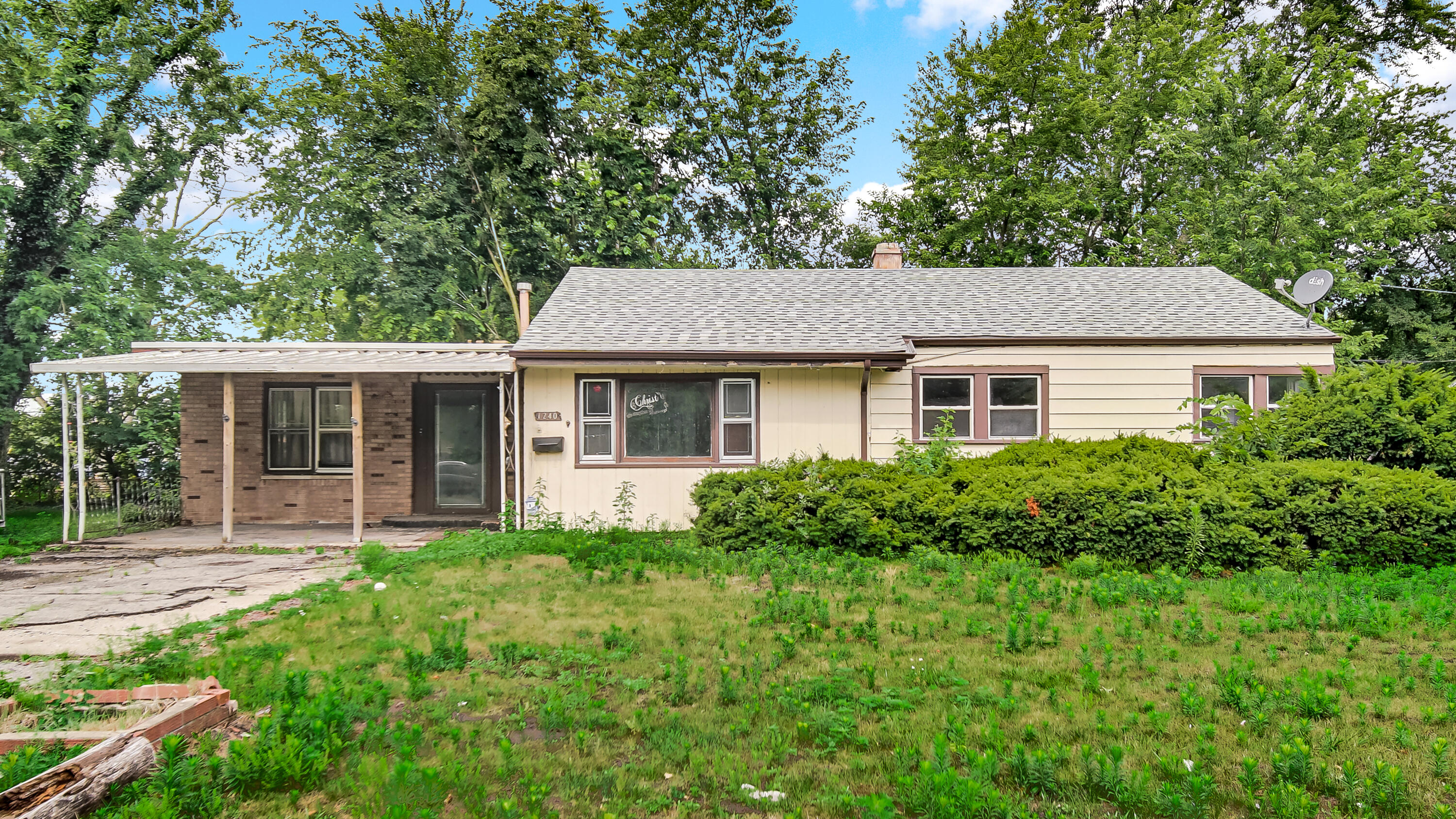 1240 Benton Street Gary, IN 46403 - Photo 1 of 4 a front view of a house with a yard and porch