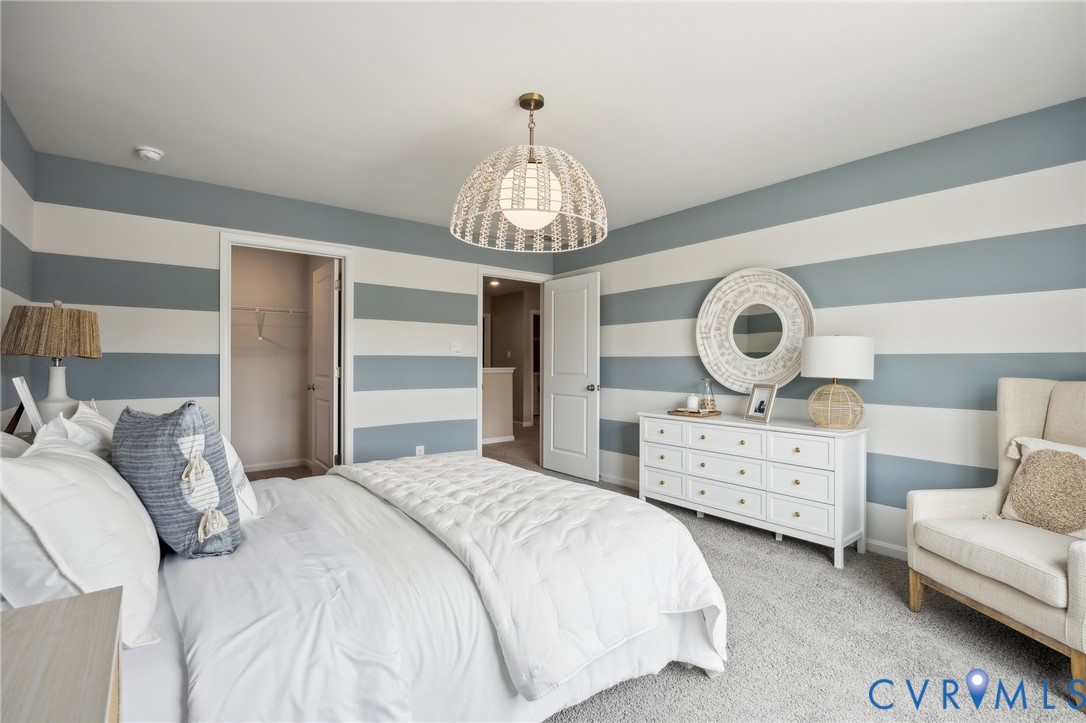 211 Happy Valley Road Keswick, VA 22947 - Photo 23 of 31 a bedroom with bed and a chandelier