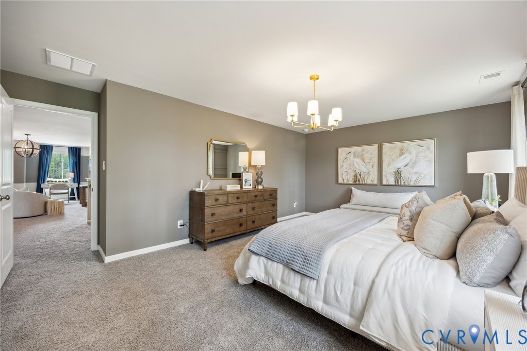 211 Happy Valley Road Keswick, VA 22947 - Photo 26 of 31 a bedroom with a bed and a chandelier