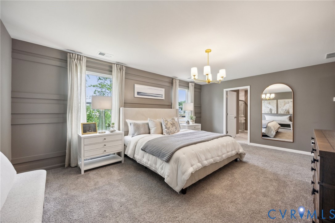 211 Happy Valley Road Keswick, VA 22947 - Photo 27 of 31 a spacious bedroom with a bed a chandelier and large window