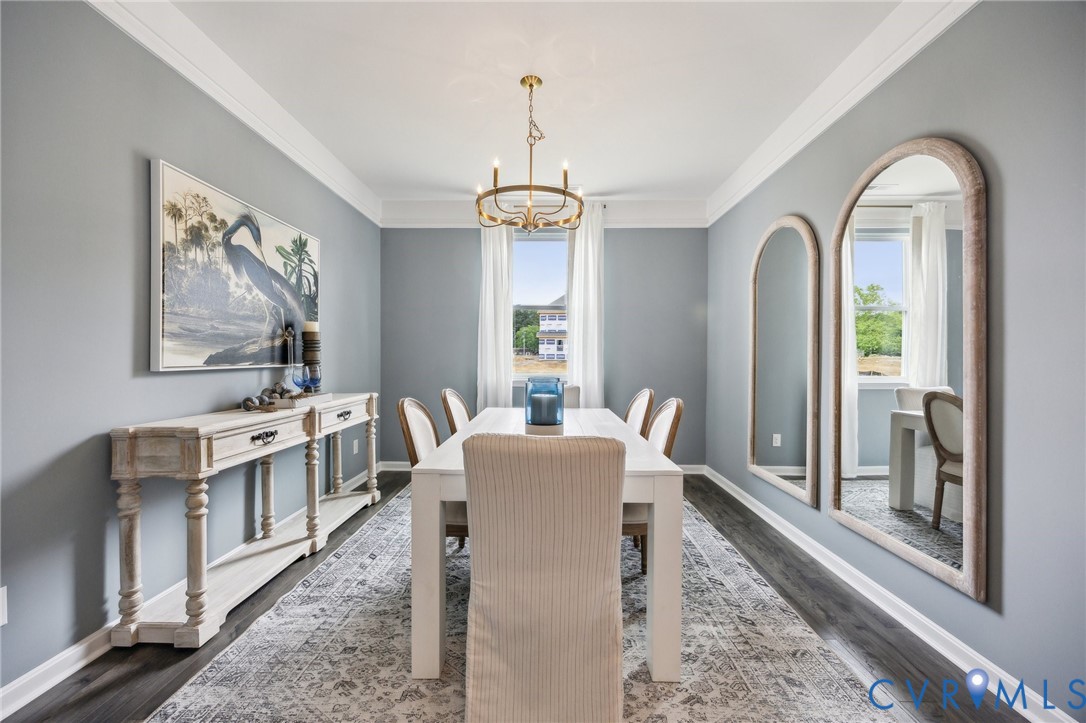 211 Happy Valley Road Keswick, VA 22947 - Photo 3 of 31 a dining room with furniture a chandelier and wooden floor