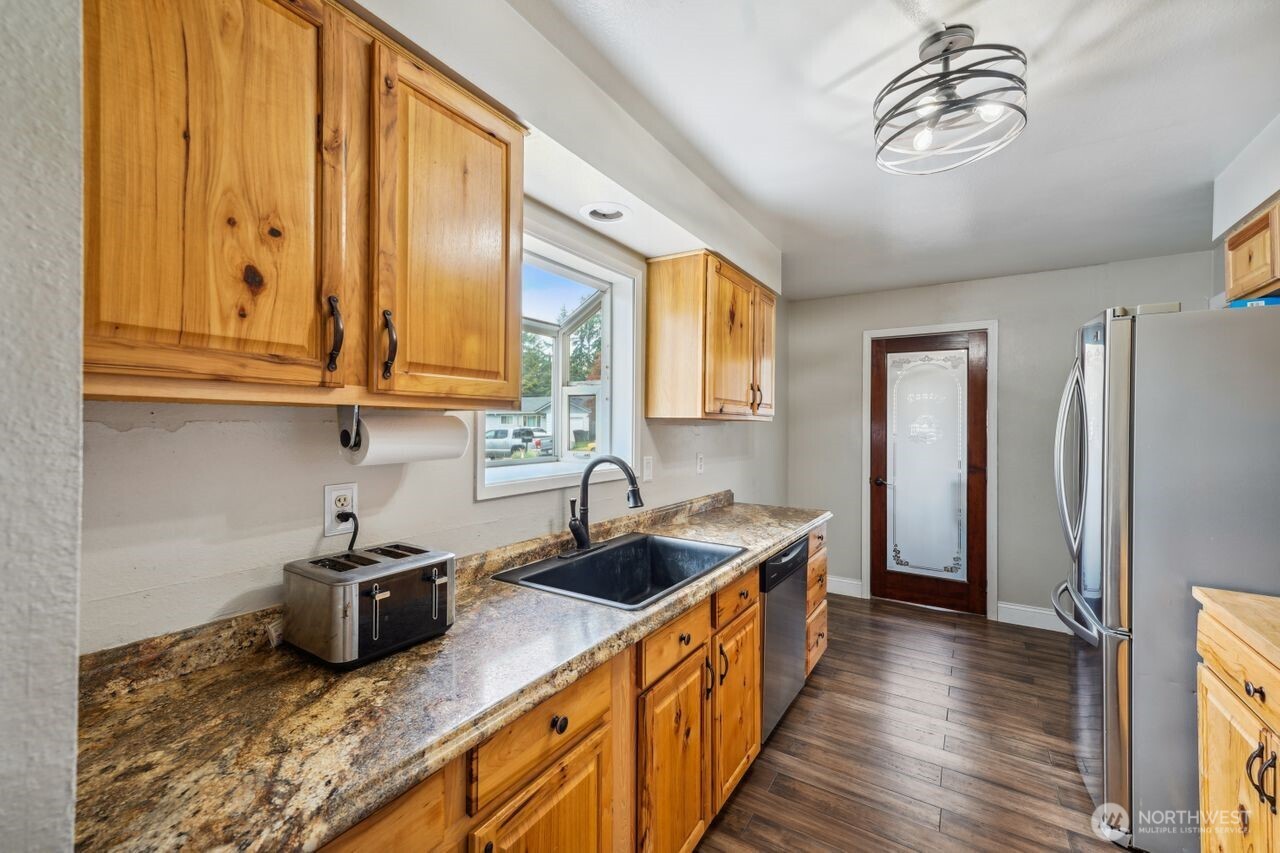3381 Nebraska Street Longview, WA 98632 - Photo 14 of 25 a kitchen with sink a refrigerator and cabinets