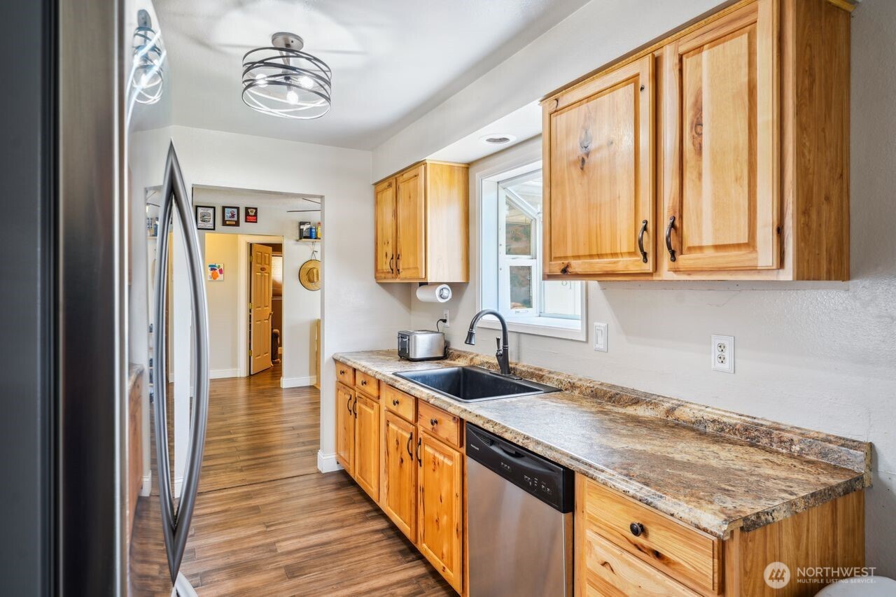 3381 Nebraska Street Longview, WA 98632 - Photo 15 of 25 a kitchen with stainless steel appliances granite countertop a sink stove and cabinets