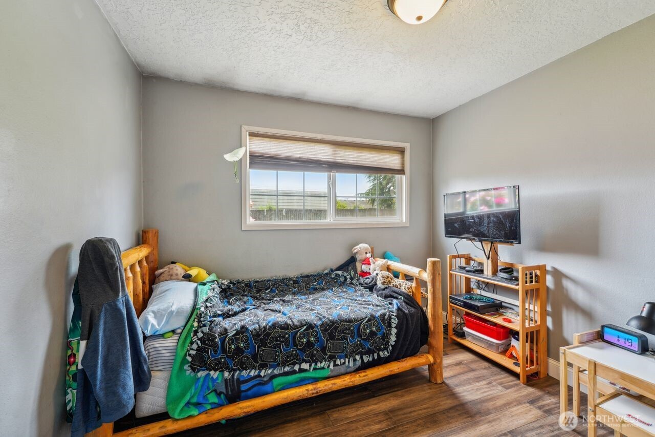 3381 Nebraska Street Longview, WA 98632 - Photo 10 of 25 a bedroom with a bed and wooden floor