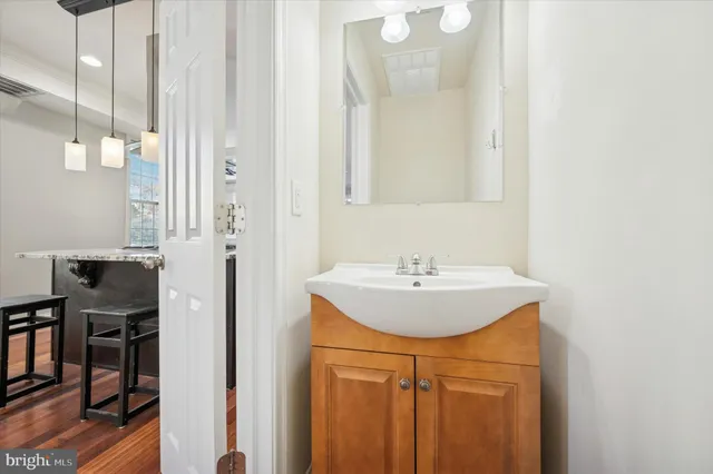 a bathroom with a sink a mirror and a shower
