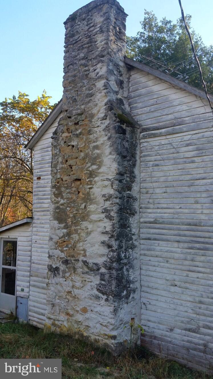 687 Scrabble Road Castleton, VA 22716 - Photo 10 of 13 a brick building with a yard