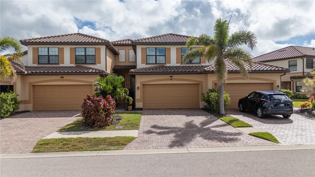 a front view of a house with a yard and garage