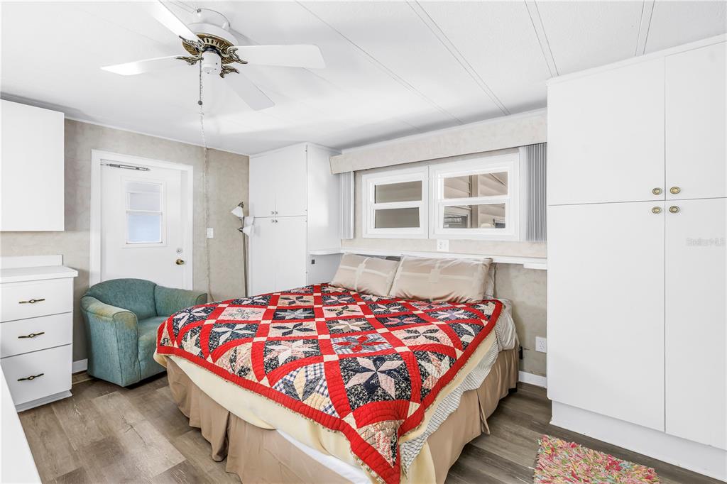 1100 South Belcher Road, Unit 502 Largo, FL 33771 - Photo 18 of 51 a bedroom with a large bed and a chandelier