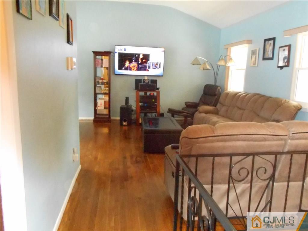 17 Kingsbridge Road Somerset, NJ 08873 - Photo 4 of 11 a living room with furniture and a flat screen tv