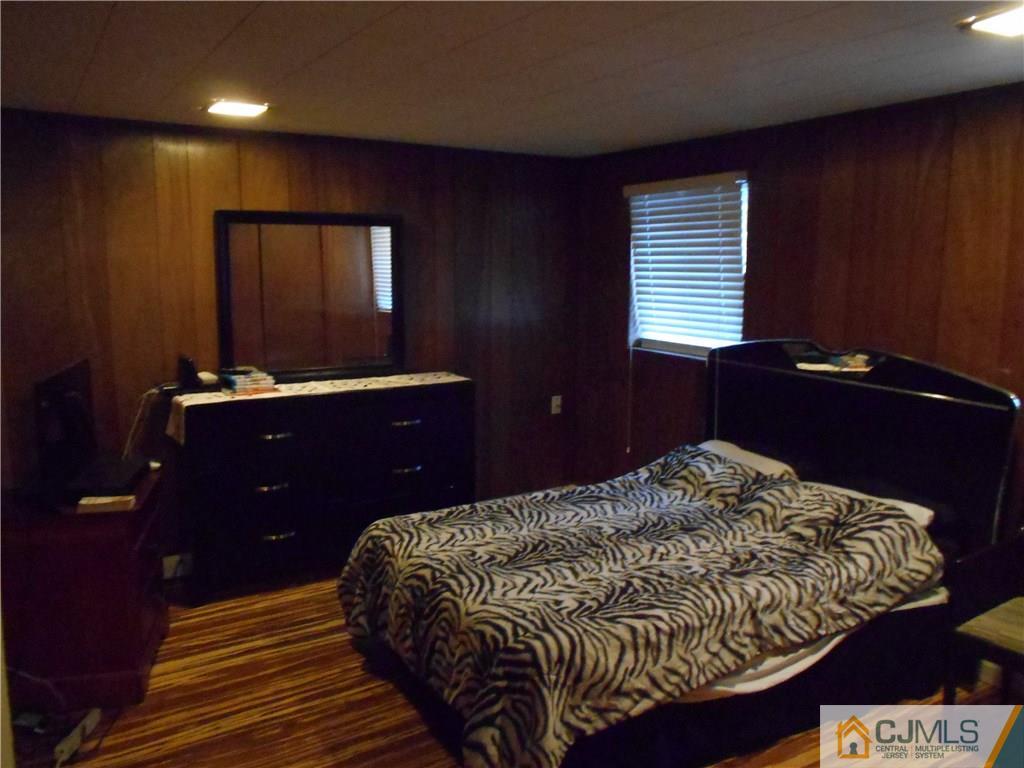 17 Kingsbridge Road Somerset, NJ 08873 - Photo 6 of 11 a bedroom with a bed and a dresser