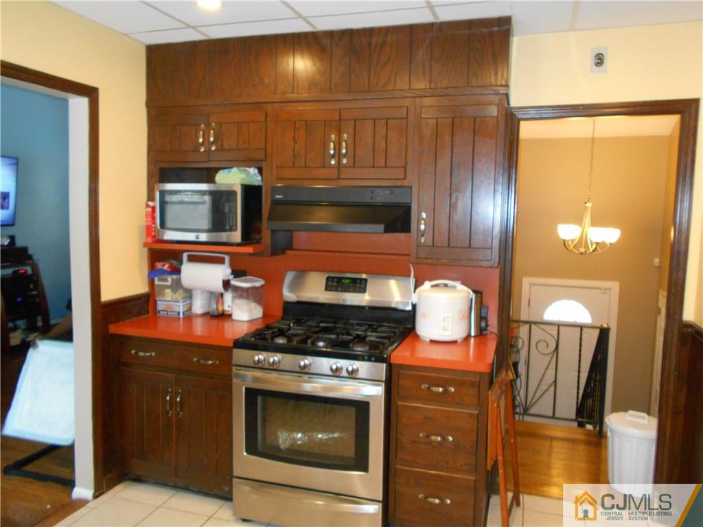 17 Kingsbridge Road Somerset, NJ 08873 - Photo 9 of 11 a kitchen with stainless steel appliances a stove a washer and dryer