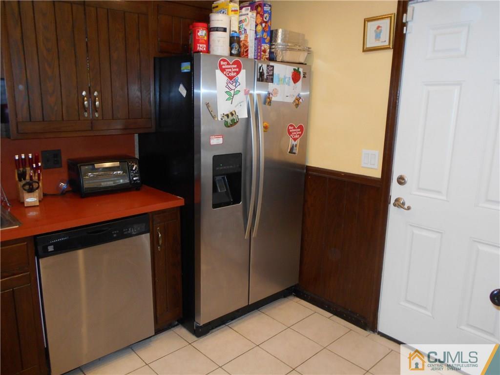 17 Kingsbridge Road Somerset, NJ 08873 - Photo 10 of 11 a kitchen with refrigerator and cabinets