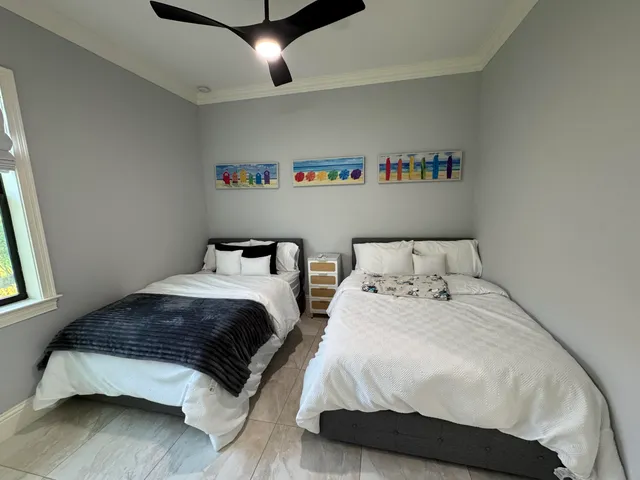 a bedroom with a white bed and a couch