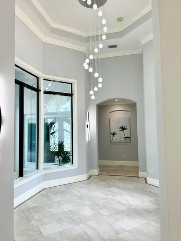 en empty room with mirror and fan