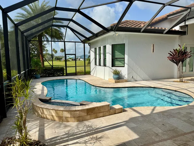 a view of a house with swimming pool and porch with furniture