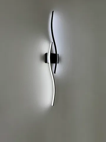 a living room with stainless steel appliances kitchen island furniture and a flat screen tv