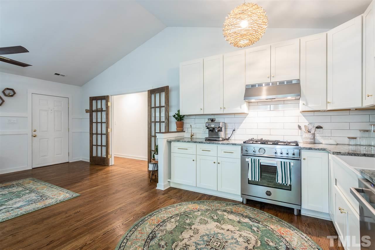 1024 Mills Street Raleigh, NC 27608 - Photo 13 of 30 a kitchen with granite countertop a stove a sink and a refrigerator