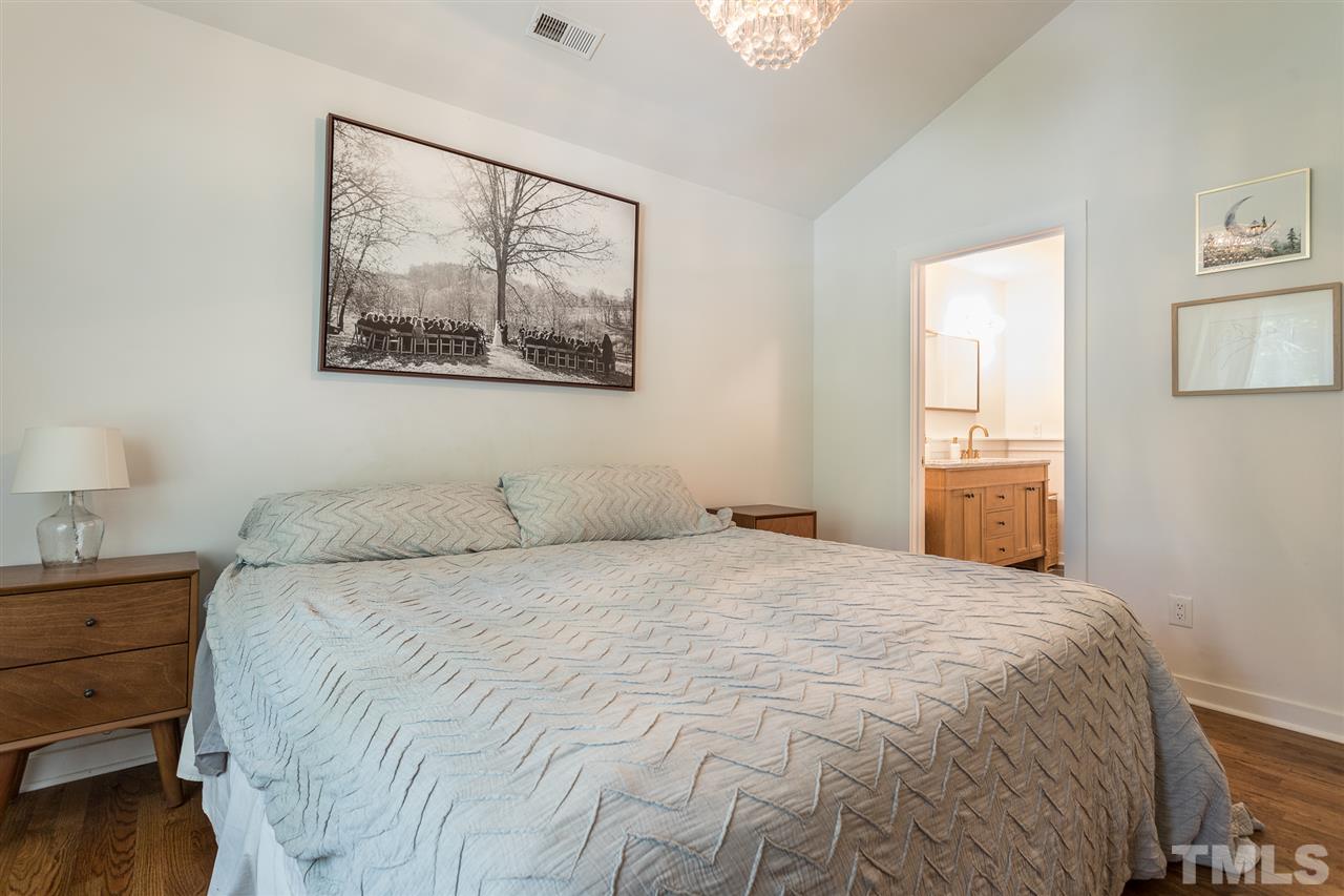 1024 Mills Street Raleigh, NC 27608 - Photo 16 of 30 a bedroom with a bed and a window