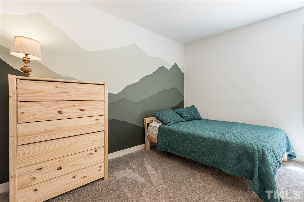 1024 Mills Street Raleigh, NC 27608 - Photo 21 of 30 a bedroom with a bed and a dresser