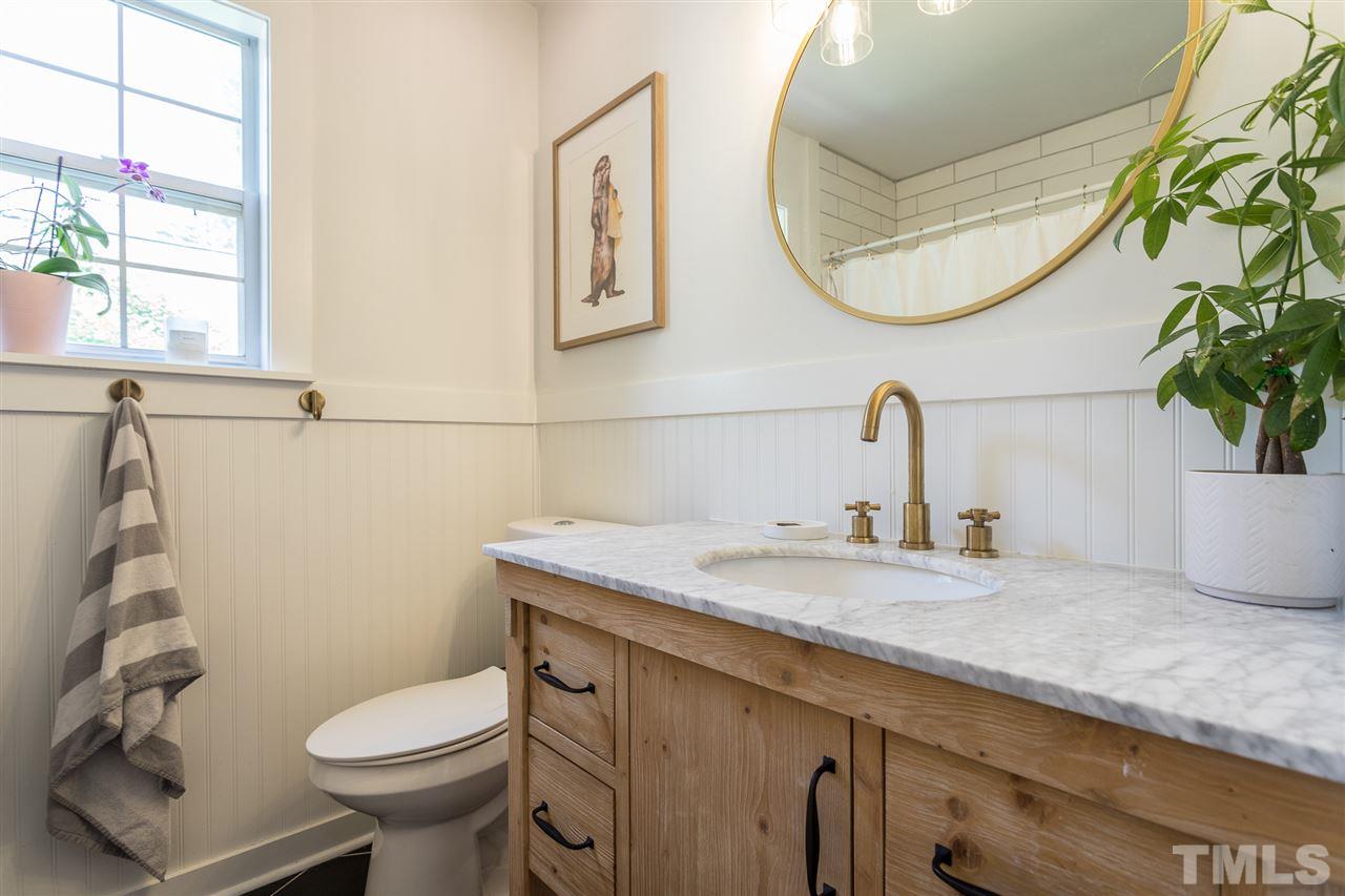 1024 Mills Street Raleigh, NC 27608 - Photo 22 of 30 a bathroom with a granite countertop toilet sink and mirror