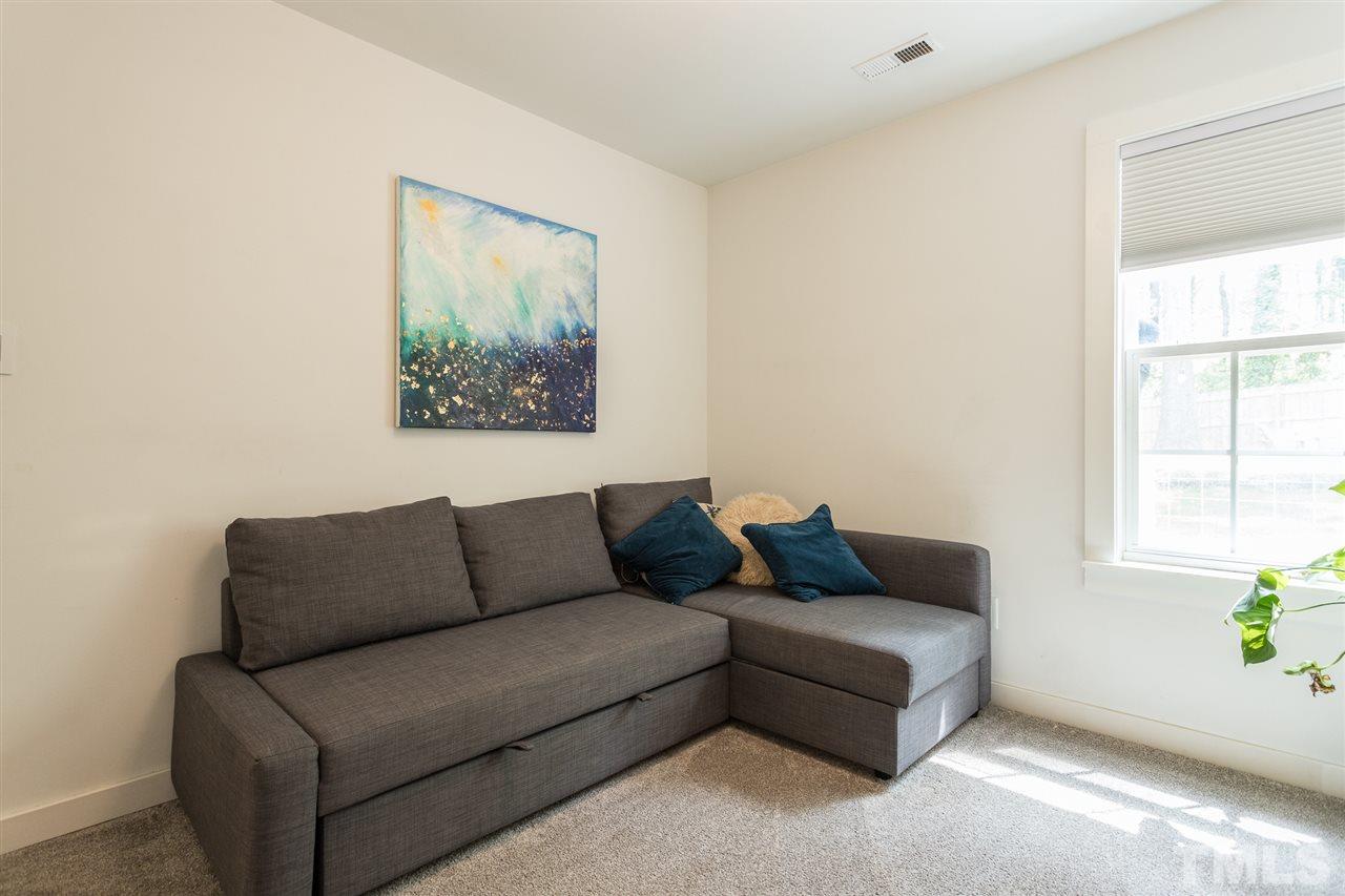 1024 Mills Street Raleigh, NC 27608 - Photo 23 of 30 a living room with furniture and a window