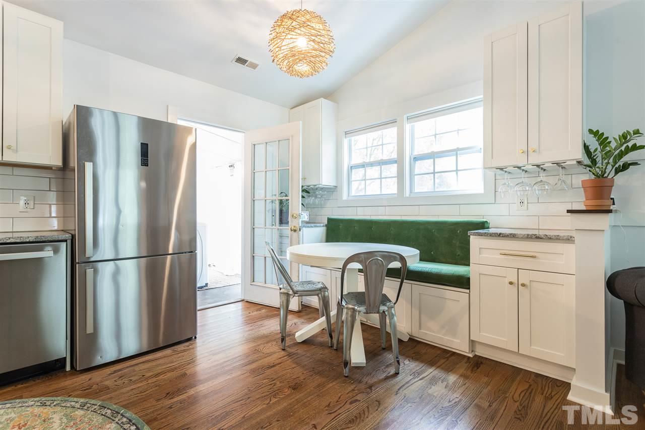 1024 Mills Street Raleigh, NC 27608 - Photo 9 of 30 a kitchen with stainless steel appliances granite countertop a dining table chairs a refrigerator and a sink