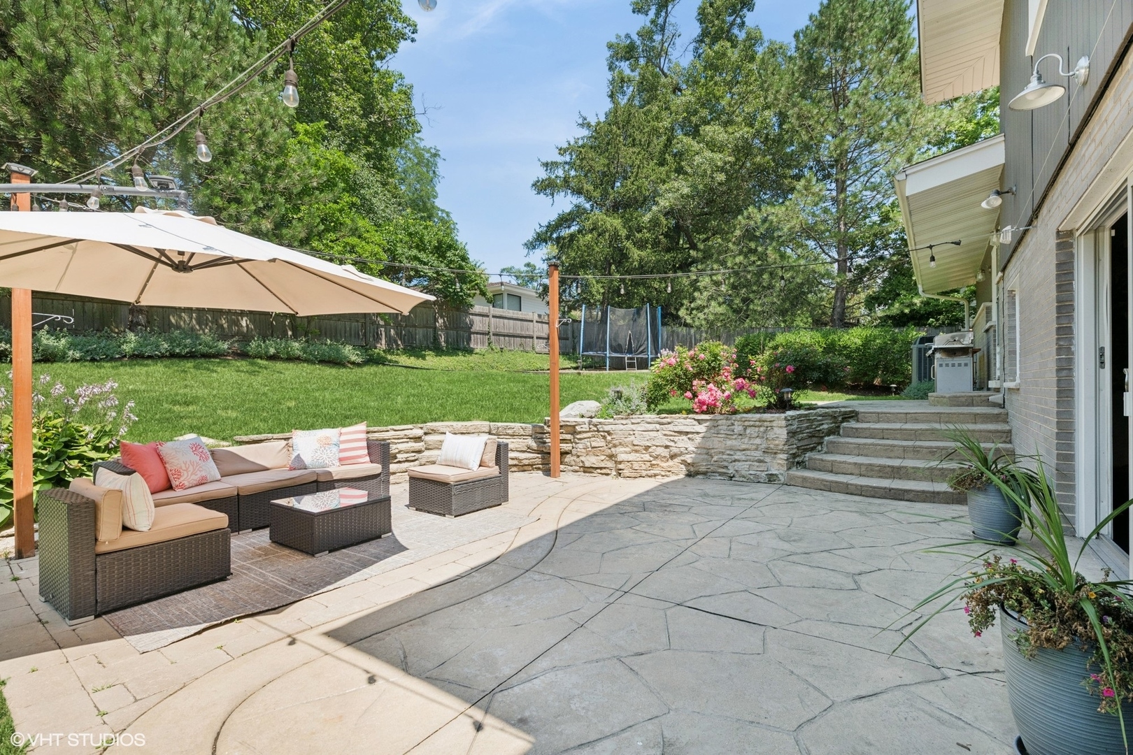 551 Dundee Road Glencoe, IL 60022 - Photo 30 of 38 a view of a patio with couches and table and chairs under an umbrella