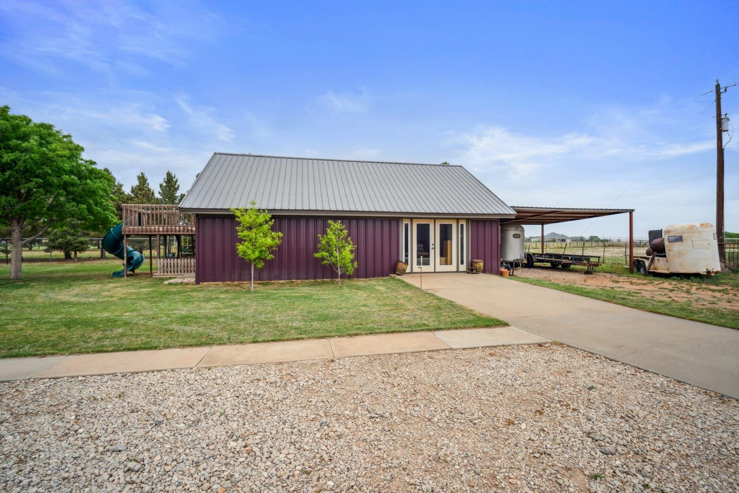 9002 Woodrow Road Wolfforth, TX 79382 - Photo 12 of 48 a front view of a house with a yard and garage
