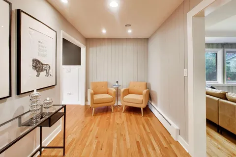 a living room with furniture and wooden floor