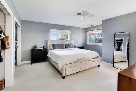 a bedroom with a large bed and a chandelier