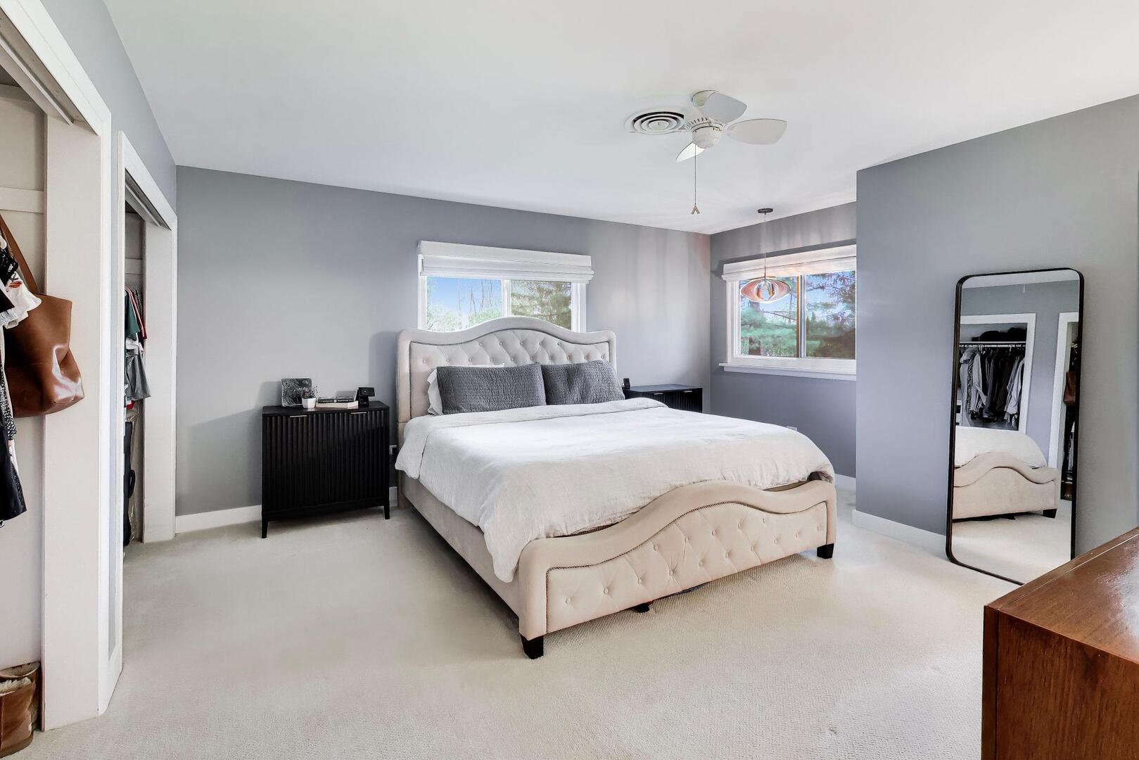 202 Grove Place Prospect Heights, IL 60070 - Photo 15 of 34 a bedroom with a large bed and a chandelier