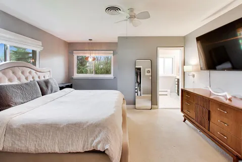 a bedroom with a large bed and a flat screen tv