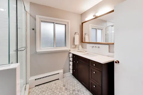 a bathroom with a sink and a mirror