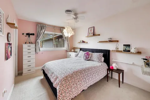 a bedroom with a bed and a dresser