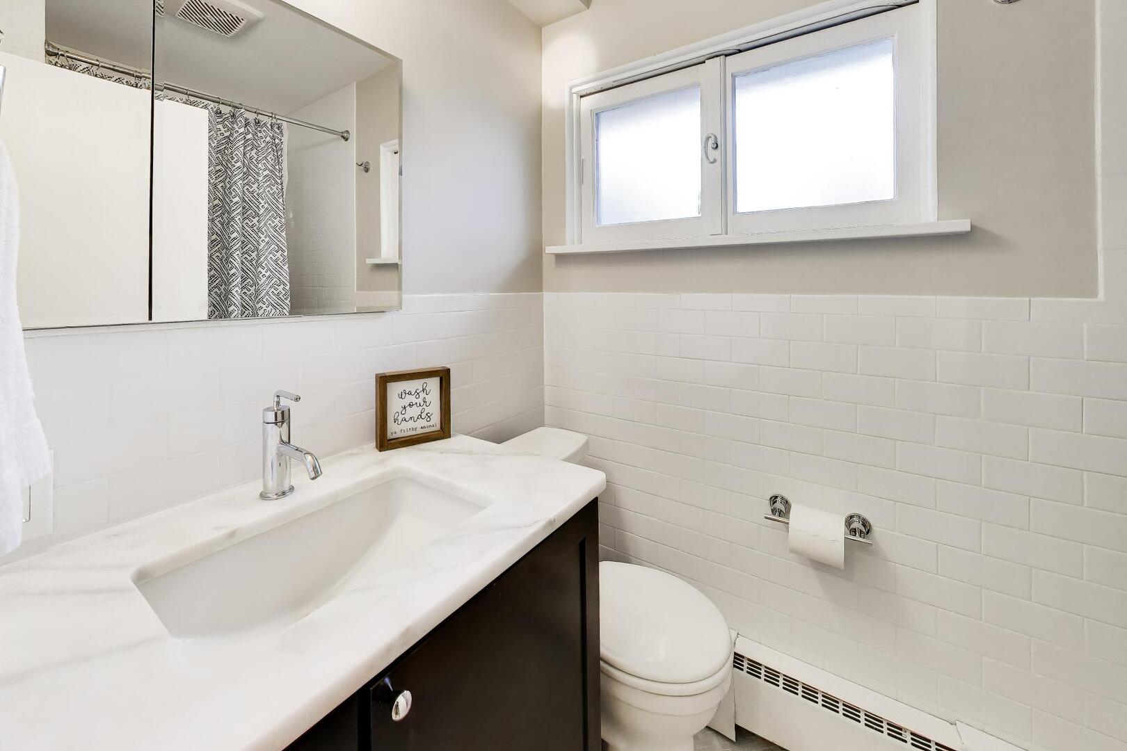 202 Grove Place Prospect Heights, IL 60070 - Photo 22 of 34 a bathroom with a sink toilet a mirror and window