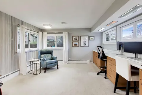 a view of a livingroom with workspace and a window