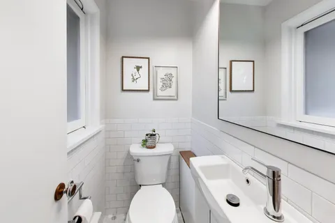 a white toilet sitting next to a bathroom sink