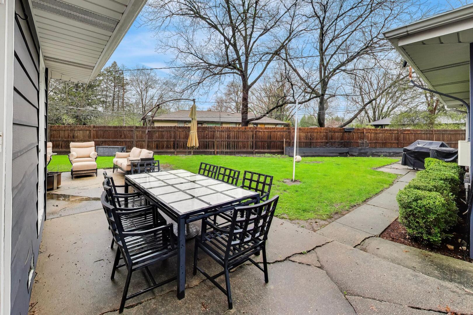 202 Grove Place Prospect Heights, IL 60070 - Photo 30 of 34 a view of a backyard with table and chairs with wooden fence and plants