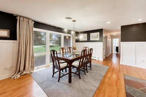 a dining room with furniture and window
