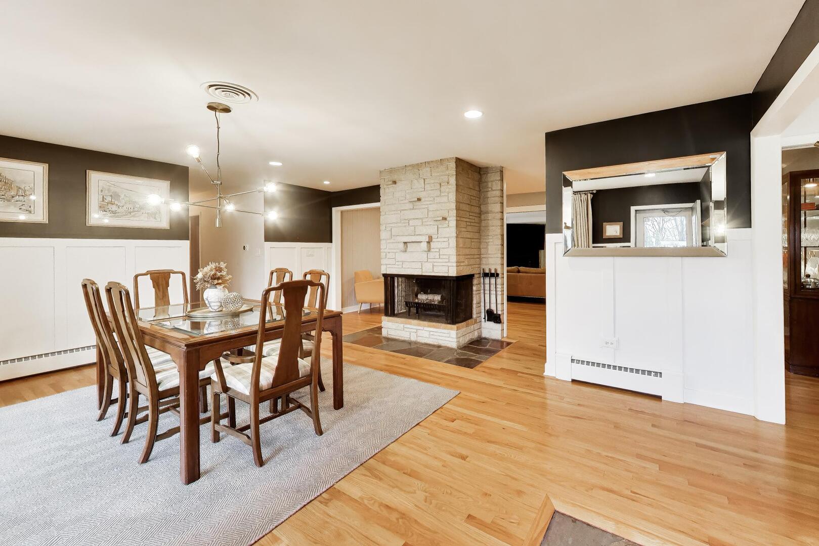202 Grove Place Prospect Heights, IL 60070 - Photo 5 of 34 a dining room with furniture a chandelier and wooden floor