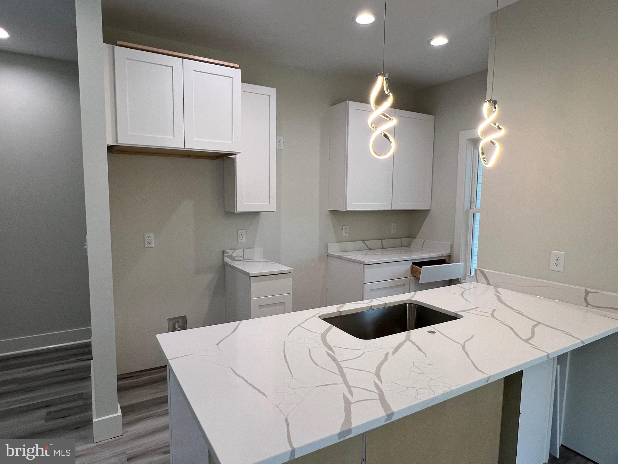 175 Rose Way Colonial Beach, VA 22443 - Photo 3 of 33 a kitchen with a white cabinets sink and stove