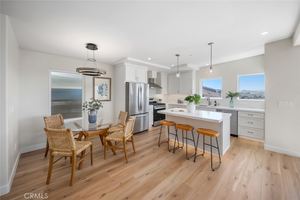 548 Blanca Street Morro Bay, CA 93442 - Photo 12 of 50 a view of a dining room with furniture and wooden floor