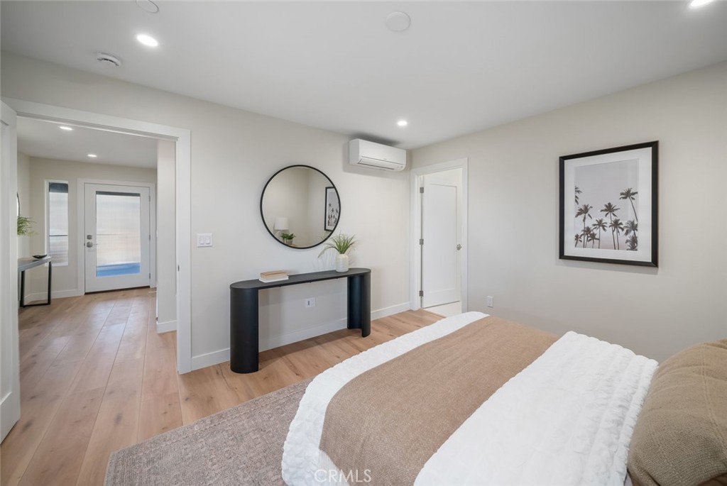 548 Blanca Street Morro Bay, CA 93442 - Photo 28 of 50 a bedroom with a bed and a chandelier