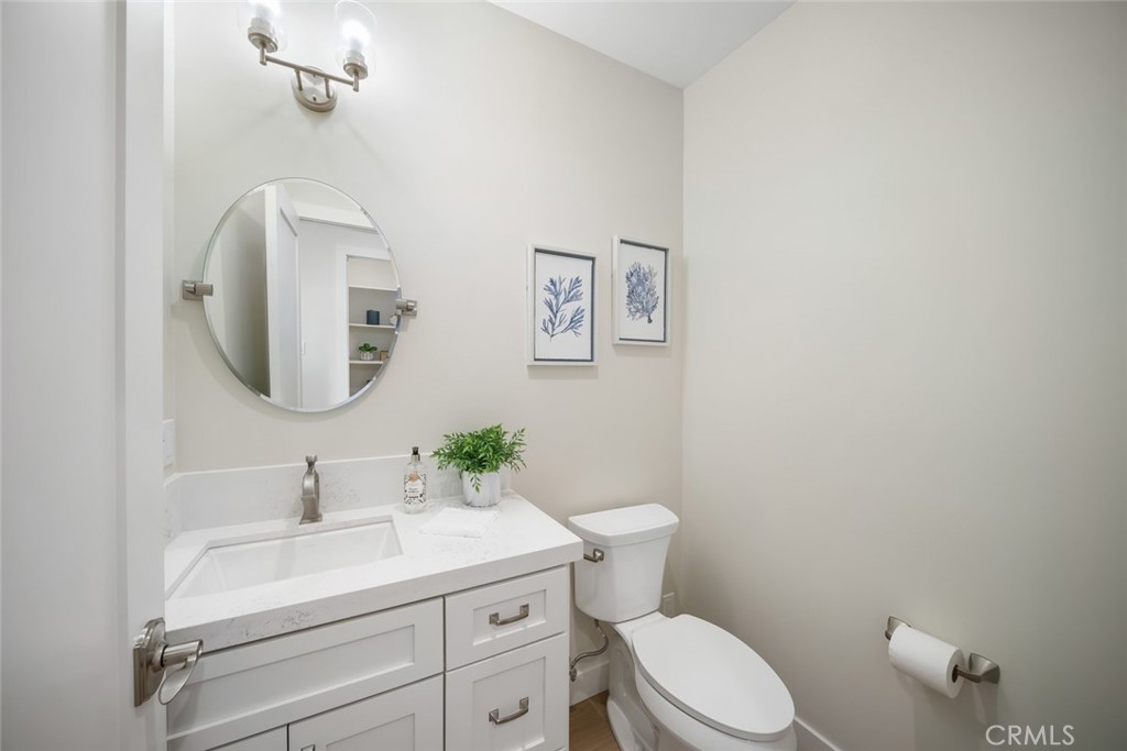 548 Blanca Street Morro Bay, CA 93442 - Photo 32 of 50 a bathroom with a toilet a sink and mirror