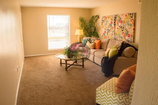 a living room with furniture and a large window